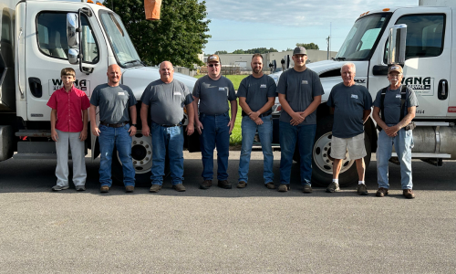 Wana Feed Service Inc. staff in front of trucks